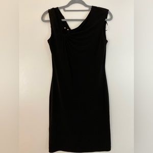 Calvin Klein Black dress with golden accessory on the right top